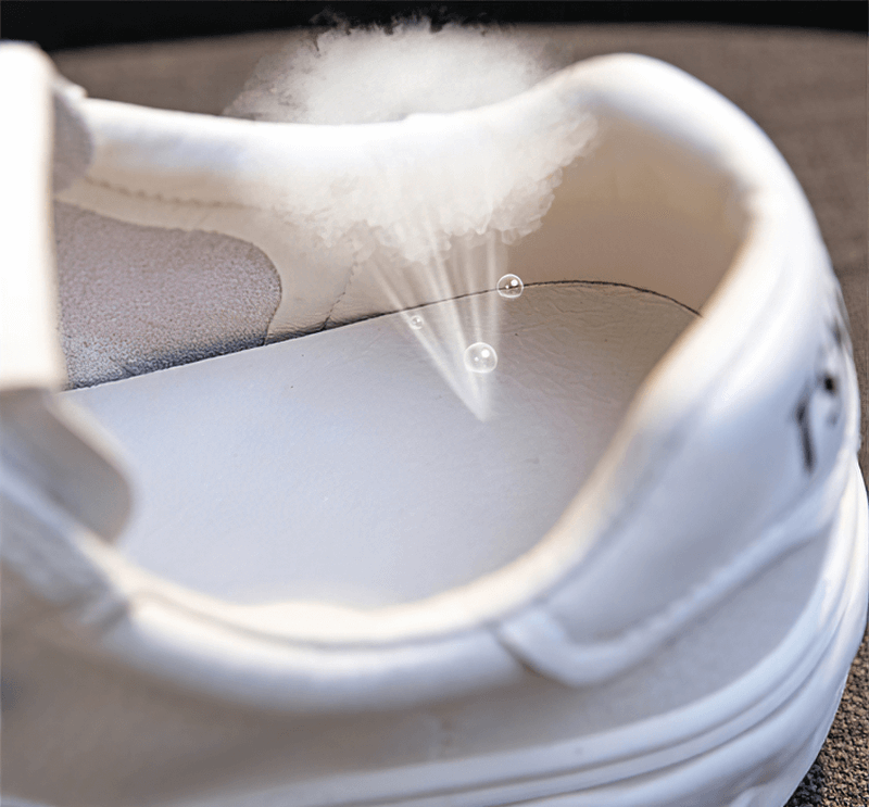 Close-up of breathable white lace-up sneaker interior with air and moisture wicking design, showing superior comfort features.